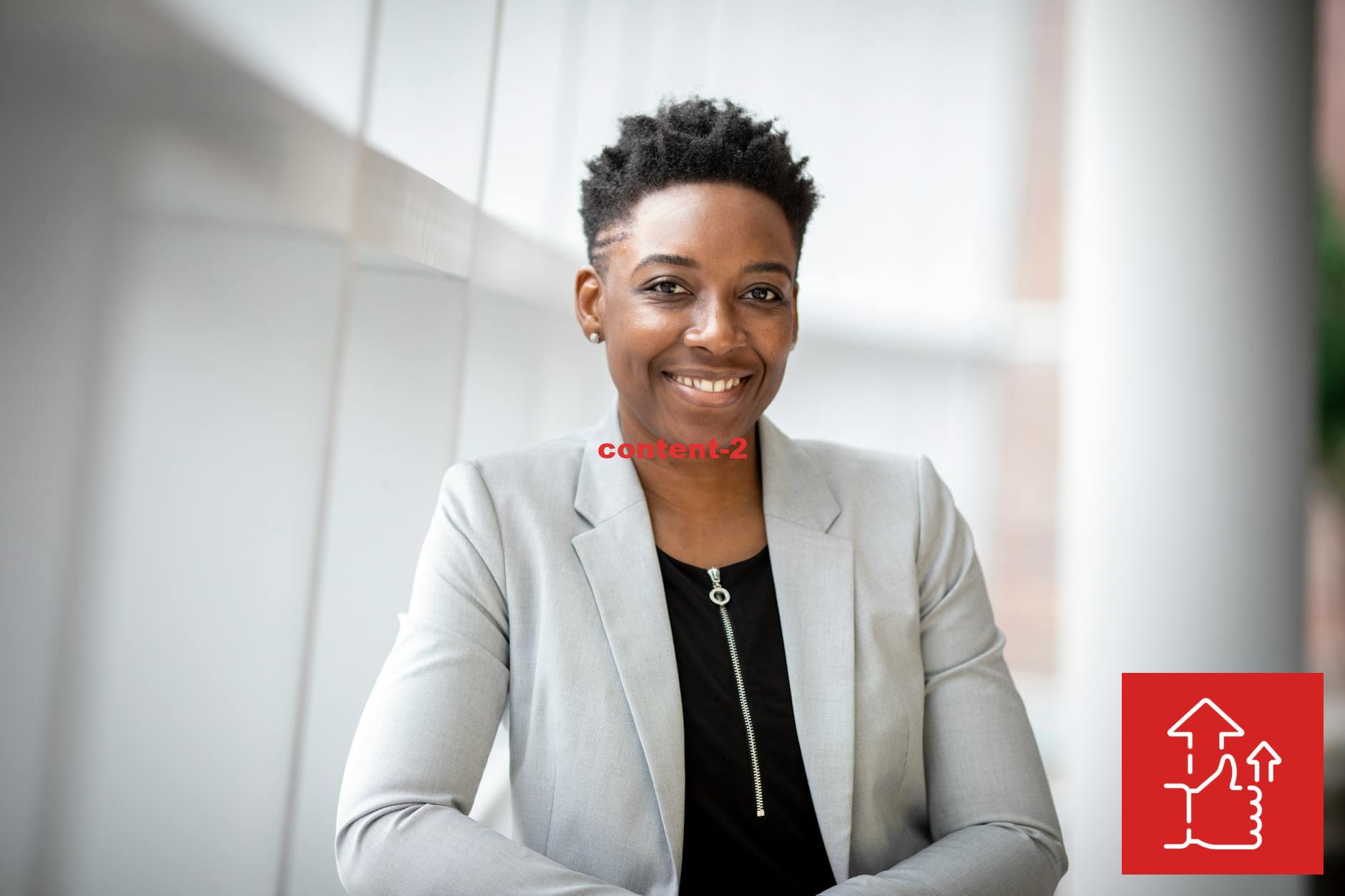 Confident African American businesswoman smiling inside a modern office space.