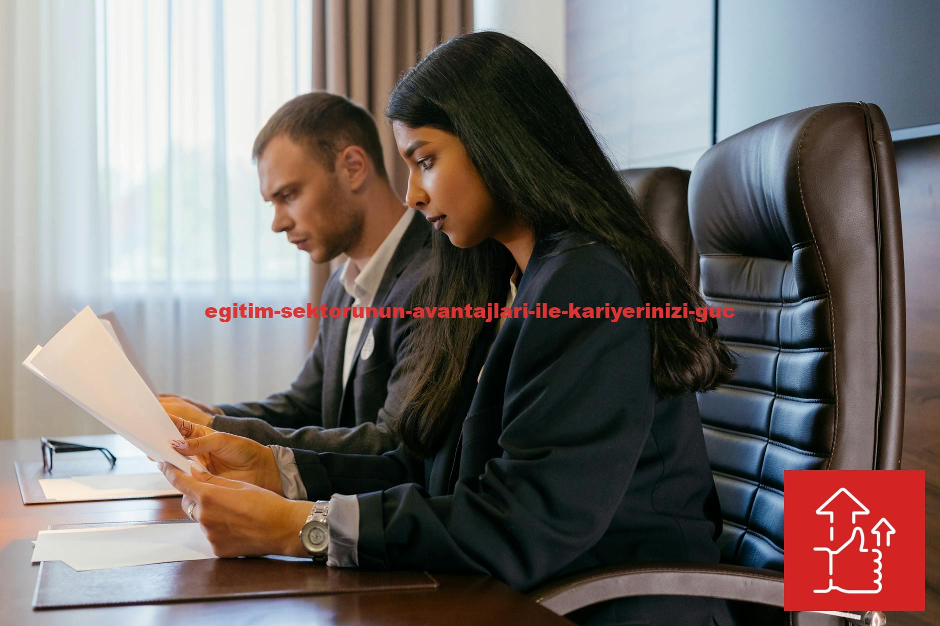 Two professionals reviewing documents in an office setting, showcasing teamwork and diversity.