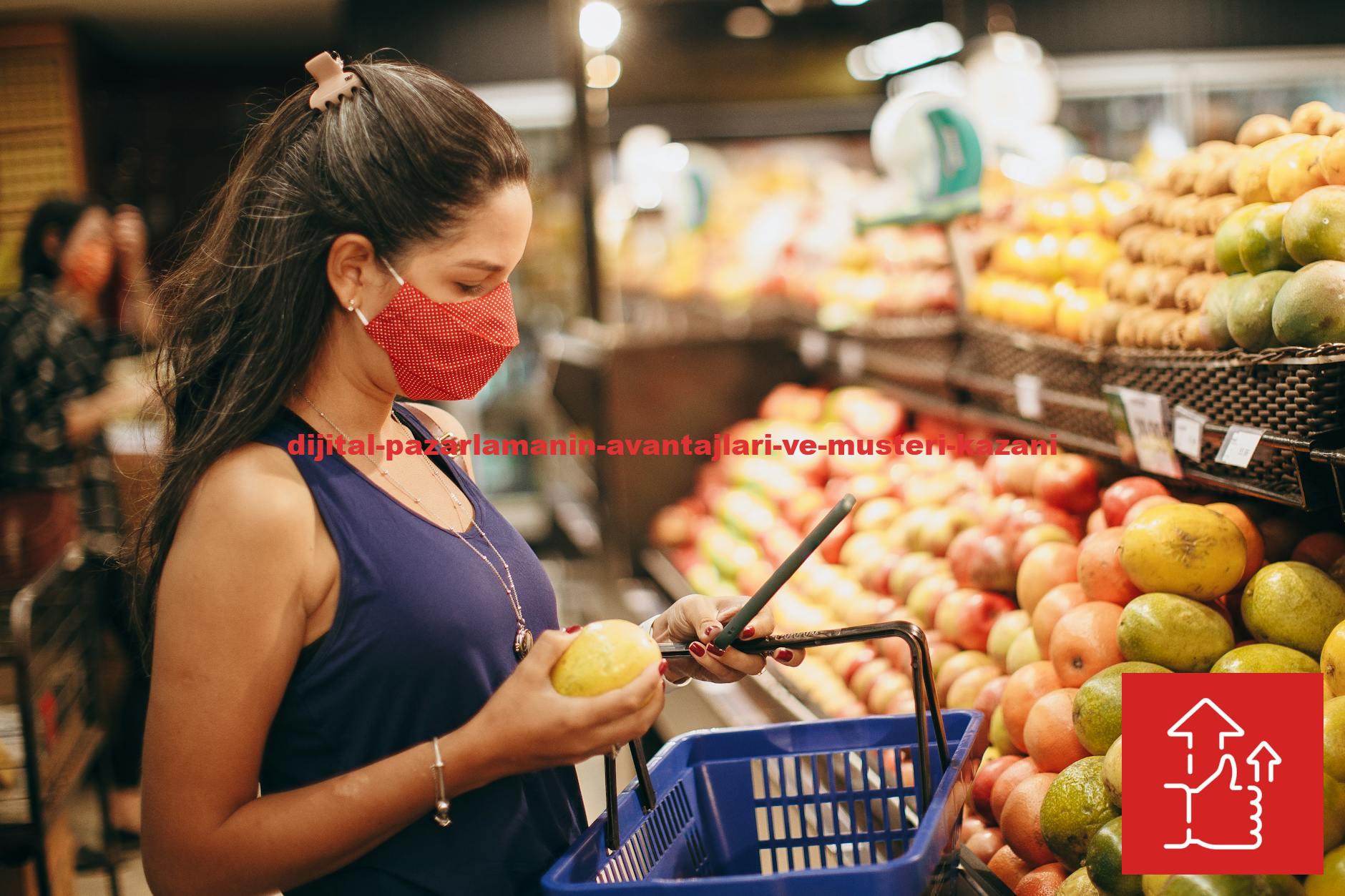 A woman wearing a mask selects fresh fruits in a supermarket produce aisle.