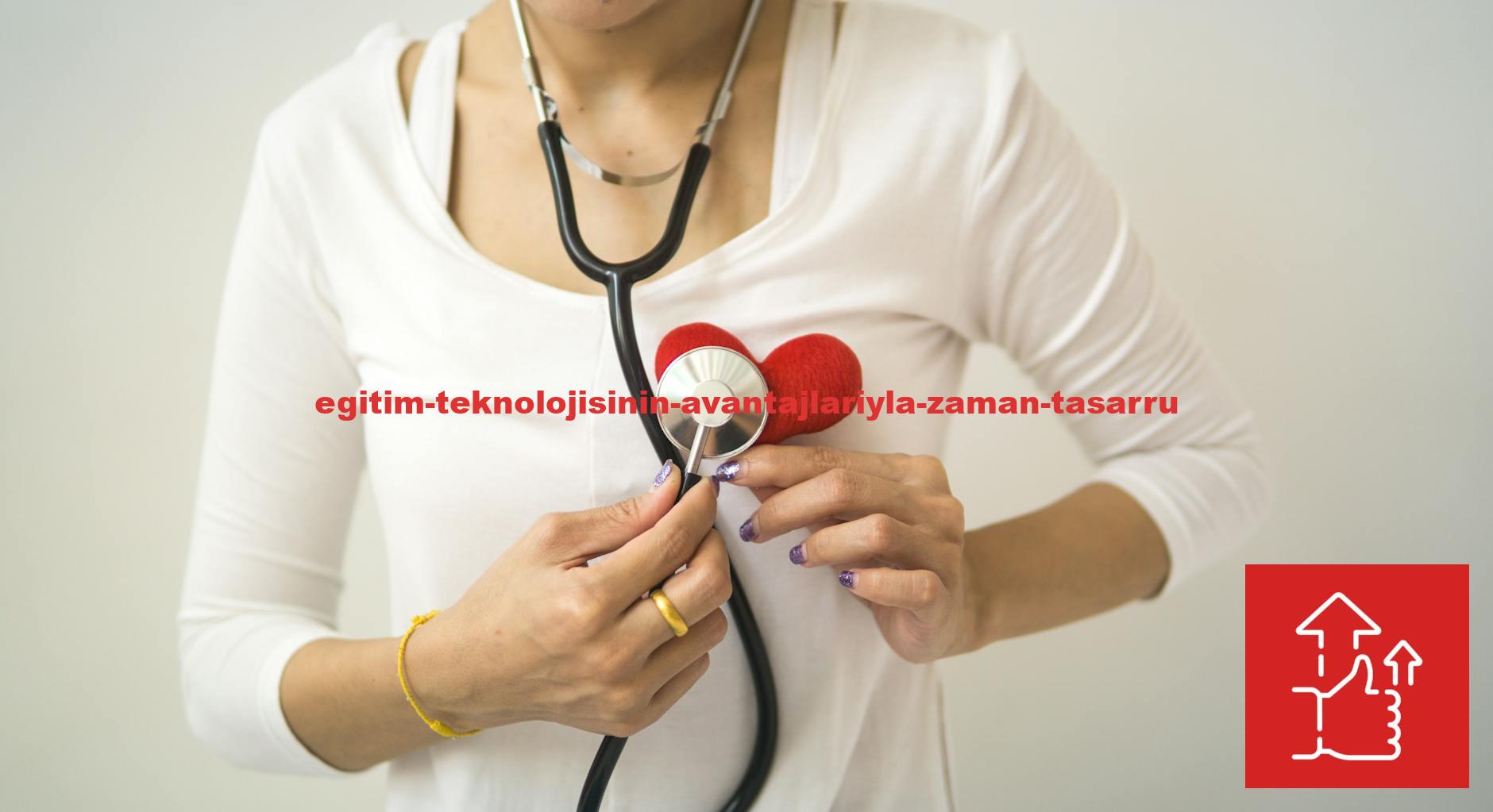 Unrecognizable female wearing white shirt while standing on white background with diaphragm of stethoscope on red handmade heart in room