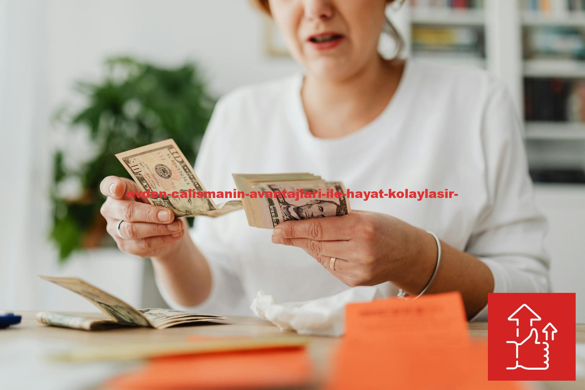 A woman sits indoors counting cash at her office desk, focusing on finances.